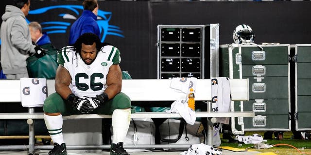 CHARLOTTE, NC - DECEMBER 15: Willie Colon #66 of the New York Jets sits alone on the bench after a loss to the Carolina Panthers at Bank of America Stadium on December 15, 2013 in Charlotte, North Carolina. The Panthers won 30-20. (Photo by Grant Halverson/Getty Images)