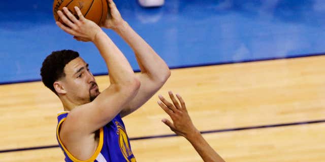 Golden State Warriors guard Klay Thompson (11) shoots over Oklahoma City Thunder guard Andre Roberson (21) during the first half in Game 6 of the NBA basketball Western Conference Finals in Oklahoma City, Saturday, May 28, 2016.