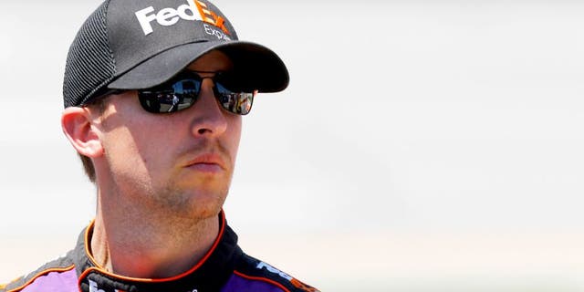 TALLADEGA, AL - MAY 02: Denny Hamlin, driver of the #11 FedEx Express Toyota, stands on the grid during qualifying for the NASCAR Sprint Cup Series GEICO 500 at Talladega Superspeedway on May 2, 2015 in Talladega, Alabama. (Photo by Jerry Markland/Getty Images)