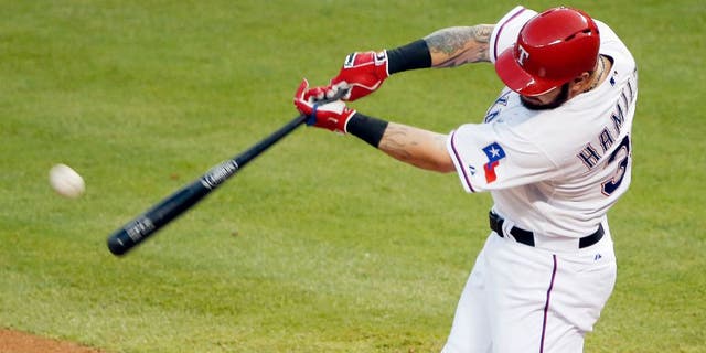 Texas Rangers Josh Hamilton makes contact for a solo home-run during the fourth inning of a baseball game against the Boston Red Sox, Friday, May 29, 2015, in Arlington, Texas. The home-run was Hamilton's second of the night. (AP Photo/Brandon Wade)
