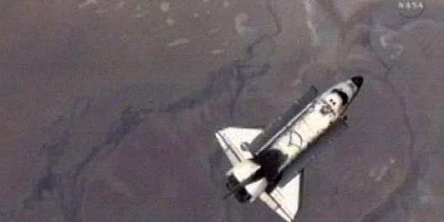 May 30: An image made from NASA Television shows the Endeavoour as it does it's fly around of the International Space Station before returning home on NASA's penultimate shuttle mission.