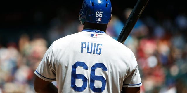 PHOENIX, AZ - APRIL 12: Yasiel Puig #66 of the Los Angeles Dodgers bats against the Arizona Diamondbacks during the MLB game at Chase Field on April 12, 2015 in Phoenix, Arizona. The Dodgers defeated the Diamondbacks 7-4. (Photo by Christian Petersen/Getty Images)