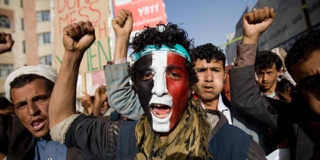 A Houthi Shiite rebel with Yemen's flag painted on his face chants slogans during a rally to show support for leader of rebels, Abdel-Malik al-Houthi in Sanaa, Yemen, Friday, Feb. 27, 2015. Yemen's Shiite rebel leader lashed out at Saudi Arabia on Thursday, accusing it of seeking to split the country following his group's power grab, as a U.N. envoy met the embattled Yemeni president who has fled the capital, Sanaa. (AP Photo/Hani Mohammed)