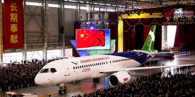 FILE - In this Monday, Nov. 2, 2015 file photo, the first twin-engine 158-seater C919 passenger plane made by The Commercial Aircraft Corp. of China (COMAC) is pulled out of the company's hangar during a ceremony near the Pudong International Airport in Shanghai, China. After years of delays, China's first large homemade passenger jetliner will take to the air for its maiden flight in the first half of this year, state media reported Monday, Feb. 6, 2017. (AP Photo, File)