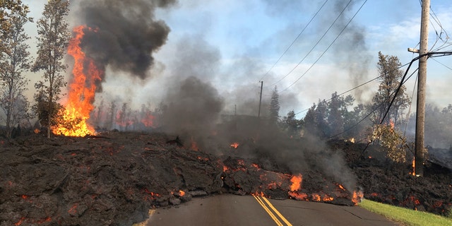 Lava from Fissure 7 slowly advances to the northeast on Hookapu Street in the Leilani Estates subdivision in Pahoa, Hawaii, May 5, 2018.