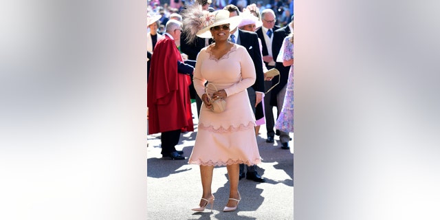 Oprah Winfrey smiles as she arrives at St George's Chapel at Windsor Castle the wedding ceremony of Prince Harry and Meghan Markle at St. George's Chapel in Windsor Castle in Windsor, near London, England, Saturday, May 19, 2018.