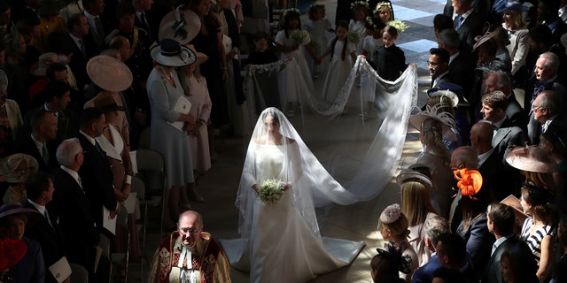 Meghan Markle walked down the aisle carrying a small bouquet of forget me not flowers picked my Prince Harry to honor Diana.