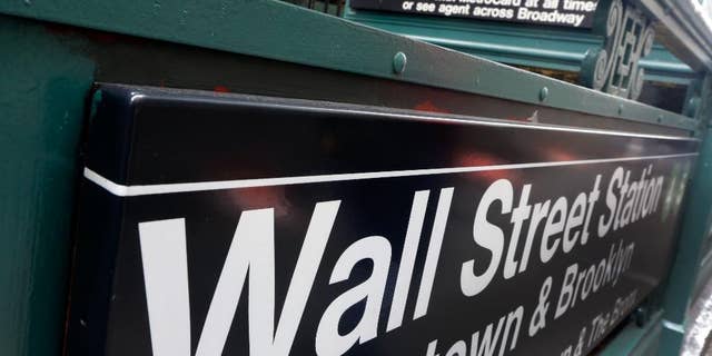 FILE-This Oct. 29, 2014 file photo shows the Wall Street subway stop on Broadway, in New York's Financial District. U.S. stocks are falling broadly in early trading on Friday, April 17, 2015, following steep declines in Europe and some results from big U.S. companies. Nine of the 10 industry groups of the Standard and Poor’s 500 are down, led by information technology companies. (AP Photo/Richard Drew)