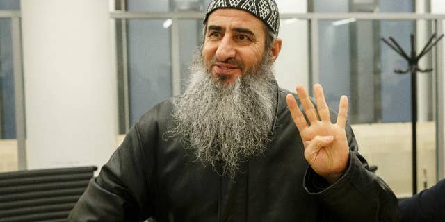 FILE - This is a Friday, Nov. 13, 2015 file photo of Najmaddin Faraj Ahmad, also known as Mullah Krekar, waves as he walks into court in Oslo. Norway's Supreme Court Wednesday Nov. 23, 2016 refused to hear an appeal by Najmaddin Faraj Ahmada radical Iraqi-born cleric who is trying to fight extradition to Italy, which suspects him of enticing recruits to fight in Iraq and Syria. The decision paves the way for Norway to hand over the cleric, to Italian authorities. (Cornelius Poppe / NTB scanpix, File via AP)