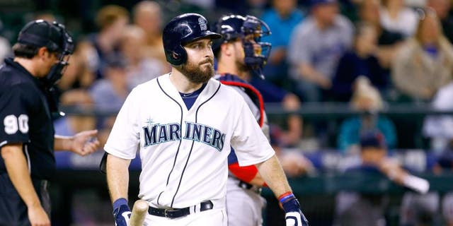 May 28, 2015; Seattle, WA, USA; Seattle Mariners left fielder Dustin Ackley (13) walks back to the dugout after striking out during the ninth inning of a 5-3 loss to the Cleveland Indians at Safeco Field. Mandatory Credit: Joe Nicholson-USA TODAY Sports