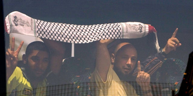June 2: Detained activists from the Gaza-bound flotilla flash victory signs as their bus arrives at Ben Gurion airport near Tel Aviv.