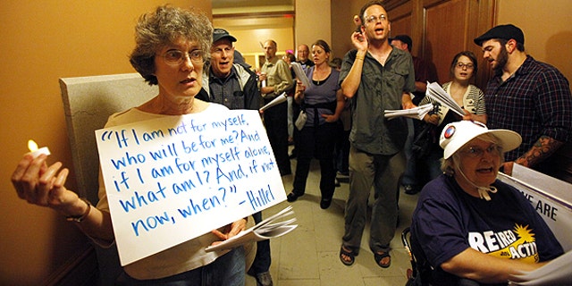 June 2: Protesters wait to be let into a meeting of the Joint Committee on Finance at the state Capitol in Madison, Wis.