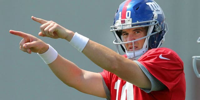 Aug 7, 2013; East Rutherford, NJ, USA; New York Giants quarterback Eli Manning (10) calls out signals in front of running back David Wilson (22) during team practice at the Quest Diagnostics Training Center. Mandatory Credit: Brad Penner-USA TODAY Sports