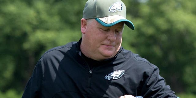 May 28, 2015; Philadelphia, PA, USA; Philadelphia Eagles head coach Chip Kelly checks his watch during OTA's at the NovaCare Complex. Mandatory Credit: Bill Streicher-USA TODAY Sports
