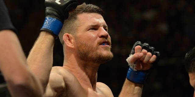 INGLEWOOD, CA - JUNE 04: Michael Bisping raises his arms to the crowd as he enters the cage for his middleweight championship bout at UFC 199 at The Forum on June 4, 2016 in Inglewood, California. (Photo by Jayne Kamin-Oncea/Getty Images)