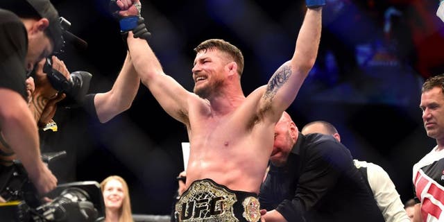INGLEWOOD, CA - JUNE 04: Michael Bisping of England celebrates after his first round knockout win against Luke Rockhold in their UFC middleweight championship bout during the UFC 199 event at The Forum on June 4, 2016 in Inglewood, California. (Photo by Harry How/Zuffa LLC/Zuffa LLC via Getty Images)