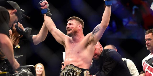 INGLEWOOD, CA - JUNE 04: Michael Bisping of England celebrates after his first round knockout win against Luke Rockhold in their UFC middleweight championship bout during the UFC 199 event at The Forum on June 4, 2016 in Inglewood, California. (Photo by Harry How/Zuffa LLC/Zuffa LLC via Getty Images)