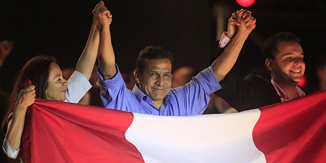 June 5: Peru's presidential candidate Ollanta Humala, center, raises hands with his running mates First Vice President Marisol Espinoza, left, and Second Vice President Omar Chehade after the presidential runoff election in Lima, Peru.