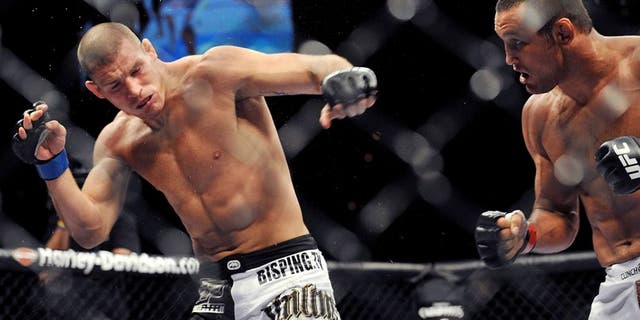LAS VEGAS - JULY 11: UFC Middleweights Dan Henderson (R) battles Michael Bisping (L) during their Middleweight bout at UFC 100 the Mandalay Bay Hotel and Casino on July 11, 2009 in Las Vegas, Nevada. (Photo by Jon Kopaloff/Getty Images)