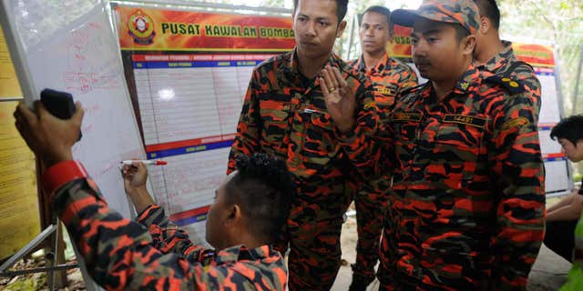 June 6, 2015: Members of the Malaysian rescue team plan as they wait for victims to be evacuated a day after an earthquake in Kundasang, a town in the district of Ranau, Malaysia.
