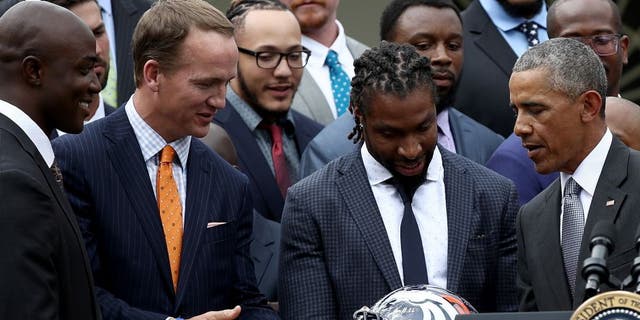 WASHINGTON, DC - JUNE 06: U.S. President Barack Obama is presented with a Denver Broncos helmet by quarterback Peyton Manning while welcoming the National Football League Super Bowl champion Denver Broncos to the White House Rose Garden on June 6, 2016 in Washington, DC. The Broncos defeated the Carolina Panthers 24-10 in Super Bowl 50. (Photo by Win McNamee/Getty Images)