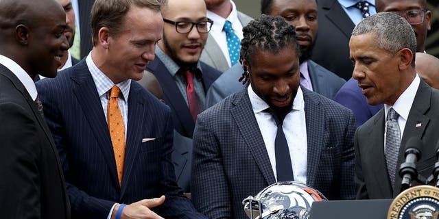 WASHINGTON, DC - JUNE 06: U.S. President Barack Obama is presented with a Denver Broncos helmet by quarterback Peyton Manning while welcoming the National Football League Super Bowl champion Denver Broncos to the White House Rose Garden on June 6, 2016 in Washington, DC. The Broncos defeated the Carolina Panthers 24-10 in Super Bowl 50. (Photo by Win McNamee/Getty Images)