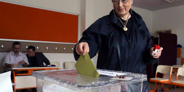 June 7, 2015: Turkish woman Emine Melike Ozmumcu casts her vote at a polling station in a primary school in Ankara, Turkey.