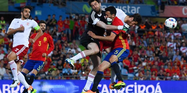 GETAFE, SPAIN - JUNE 07: Sergio Busquets of Spain collides with the goalkeeper Revishvili of Georgia during an international friendly match between Spain and Georgia at Alfonso Perez stadium on June 7, 2016 in Getafe, Spain. (Photo by David Ramos/Getty Images)