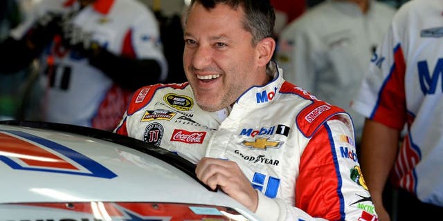 NASCAR Sprint Cup Series driver Tony Stewart laughs with members of his team as he climbs into his car for practice at Charlotte Motor Speedway in Concord, N.C., on Thursday, May 26, 2016. (Jeff Siner/Charlotte Observer/TNS via Getty Images)