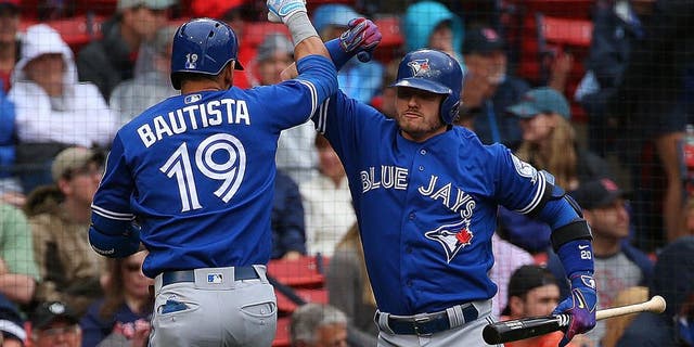 BOSTON, MA - JUNE 5: Jose Bautista #19 of the Toronto Blue Jays celebrates his home run with Josh Donaldson #20 against the Boston Red Sox in the first inning at Fenway Park on June 5, 2016 in Boston, Massachusetts. (Photo by Jim Rogash/Getty Images)