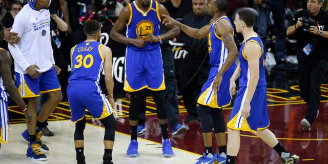 Golden State Warriors forward Kevin Durant (35) celebrates with teammates after the Warriors defeated the Cleveland Cavaliers 118-113 in Game 3 of basketball's NBA Finals in Cleveland, Wednesday, June 7, 2017.