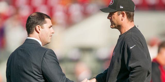 Dec 28, 2014; Santa Clara, CA, USA; San Francisco 49ers chief executive officer Jed York (left) shakes hands with head coach Jim Harbaugh (right) before the game against the Arizona Cardinals at Levi's Stadium. Mandatory Credit: Ed Szczepanski-USA TODAY Sports