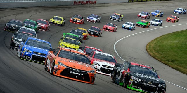 BROOKLYN, MI - JUNE 14: Carl Edwards, driver of the #19 ARRIS Toyota, and Kasey Kahne, driver of the #5 Great Clips Chevrolet, lead a pack of cars during the NASCAR Sprint Cup Series Quicken Loans 400 at Michigan International Speedway on June 14, 2015 in Brooklyn, Michigan. (Photo by Robert Laberge/NASCAR via Getty Images)