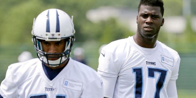 Tennessee Titans wide receivers Dorial Green-Beckham (17) and Rico Richardson (81) watch teammates run a drill during an organized team activity at the team's NFL football training facility Monday, June 8, 2015, in Nashville, Tenn. An aggravated hamstring has limited Green-Beckham, who is working to reform his image after off-field issues dropped him into the second round of the draft. (AP Photo/Mark Humphrey)