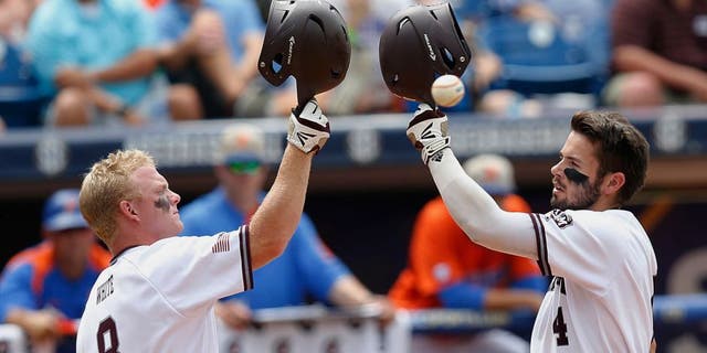 Texas A&M's Nick Banks, right, celebrates with Boomer White after Banks hits a solo home run in the third inning of the Southeastern Conference NCAA college baseball championship game at the Hoover Met, Sunday, May 29, 2016, in Hoover, Ala. Texas A&M won 12-5. (AP Photo/Brynn Anderson)