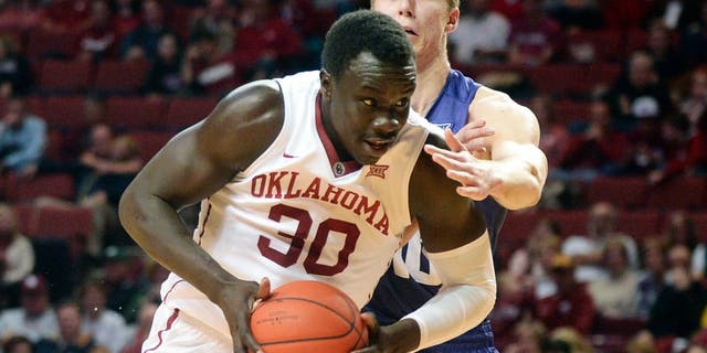 Feb 2, 2016; Norman, OK, USA; Oklahoma Sooners center Akolda Manyang (30) drives to the basket in front of TCU Horned Frogs forward Vladimir Brodziansky (10) during the second half at Lloyd Noble Center. Mandatory Credit: Mark D. Smith-USA TODAY Sports