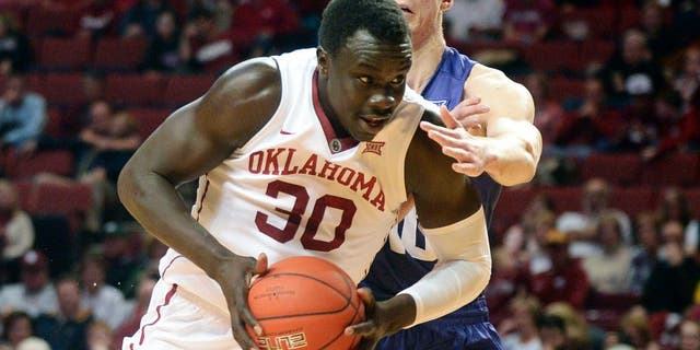 Feb 2, 2016; Norman, OK, USA; Oklahoma Sooners center Akolda Manyang (30) drives to the basket in front of TCU Horned Frogs forward Vladimir Brodziansky (10) during the second half at Lloyd Noble Center. Mandatory Credit: Mark D. Smith-USA TODAY Sports