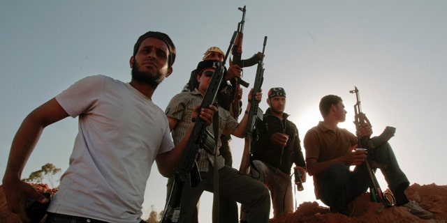 June 9: Libyan rebel fighters stand at their position at the southern front line of the city of Misrata, Libya.