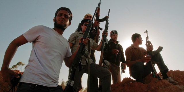 June 9: Libyan rebel fighters stand at their position at the southern front line of the city of Misrata, Libya.