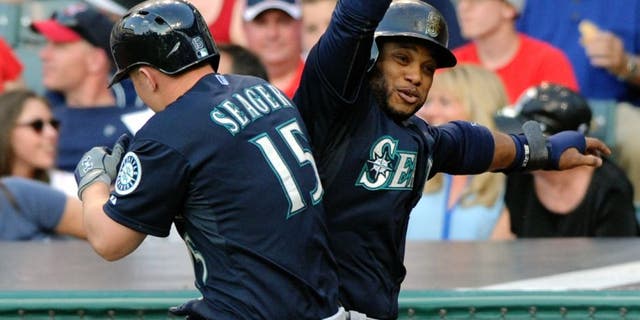 Jun 10, 2015; Cleveland, OH, USA; Seattle Mariners third baseman Kyle Seager (15) celebrates with second baseman Robinson Cano (22) after hitting a grand slam home run during the third inning against the Cleveland Indians at Progressive Field. Mandatory Credit: Ken Blaze-USA TODAY Sports