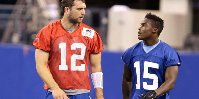 Indianapolis Colts quarterback Andrew Luck (12) talks with Phillip Dorsett during an NFL football organized team activity Wednesday, June 10, 2015, in Indianapolis. (AP Photo/Darron Cummings)