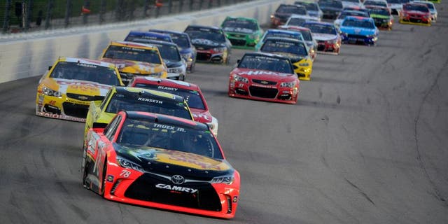 KANSAS CITY, KS - MAY 07: Martin Truex Jr., driver of the #78 Bass Pro Shops/TRACKER Boats Toyota Toyota, and Matt Kenseth, driver of the #20 Dollar General Toyota, leads the field during the NASCAR Sprint Cup Series Go Bowling 400 at Kansas Speedway on May 7, 2016 in Kansas City, Kansas. (Photo by Robert Laberge/NASCAR via Getty Images)