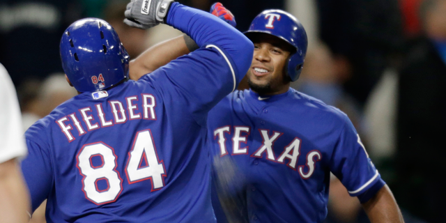 Texas Rangers' Prince Fielder celebrates with Elvis Andrus, right, after Ardus hit a solo home run on a pitch from Seattle Mariners' Steve Cishek to tie a baseball game in the ninth inning Saturday, June 11, 2016, in Seattle. (AP Photo/John Froschauer)