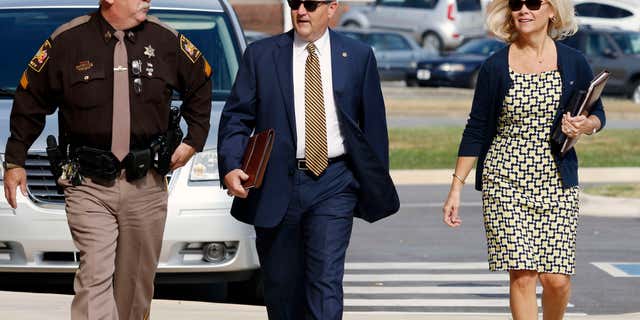 Mike , center, and Susan Hubbard walk to the Lee County Justice Center for closing arguments in the Alabama House Speaker's Trial on Friday, June 10, 2016, in Opelika, Ala.