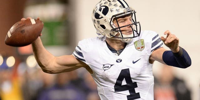 SAN FRANCISCO, CA - DECEMBER 27: Taysom Hill #4 of the BYU Cougars rolls out to pass against the Washington Huskies during the third quarter in the Fight Hunger Bowl at AT&T Park on December 27, 2013 in San Francisco, California. (Photo by Thearon W. Henderson/Getty Images) *** Local Caption *** Taysom Hill