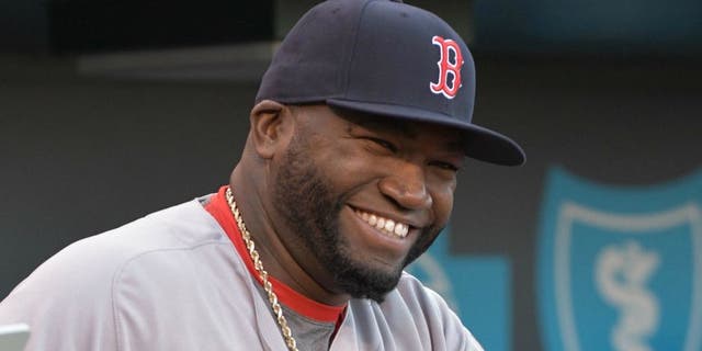 May 17, 2016; Kansas City, MO, USA; Boston Red Sox designated hitter David Ortiz (34) smiles before heading onto the field to be presented with a painting of himself in the World Series and a case of Kansas City barbecue sauces before the game against the Kansas City Royals at Kauffman Stadium. The Royals won 8-4. Mandatory Credit: Denny Medley-USA TODAY Sports