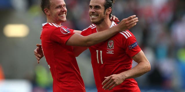 BORDEAUX, FRANCE - JUNE 11: Gareth Bale of Wales celebrates at full-time with team-mate Chris Gunther following the UEFA Euro 2016 Group B match between Wales and Slovakia at Nouveau Stade de Bordeaux on June 11, 2016 in Bordeaux, France. (Photo by Chris Brunskill Ltd/Getty Images)