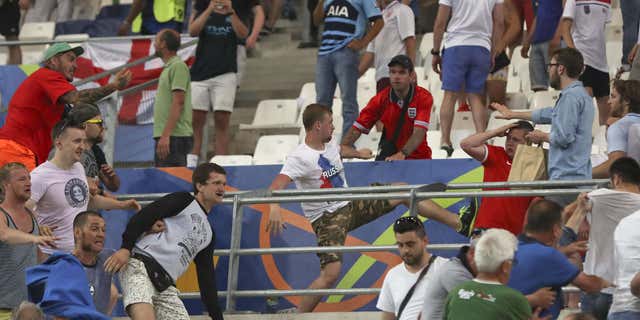 Clashes break out in the stands during the Euro 2016 Group B soccer match between England and Russia, at the Velodrome stadium in Marseille, France, Saturday, June 11, 2016.