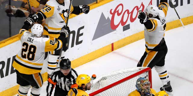 Pittsburgh Penguins' Patric Hornqvist (72), of Sweden,celebrates with Ian Cole (28) after scoring a goal against the Nashville Predators during the third period of Game 6 of the NHL hockey Stanley Cup Final, Sunday, June 11, 2017, in Nashville, Tenn.
