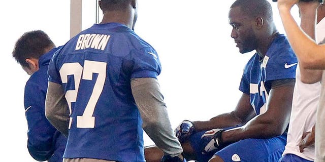 Jun 12, 2014; East Rutherford, NJ, USA; New York Giants outside linebacker Jon Beason (52) is tended to on the sidelines during New York Giants minicamp at the Quest Diagnostics Training Center. William Perlman/The Star-Ledger-USA TODAY Sports